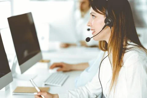 Group of diverse operators at work in call center. Beautiful asian woman sitting Stock Photos