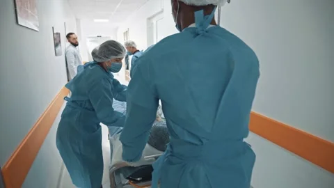 Group of diverse paramedic doctors hurrying in hospital corridor to operating 스톡 동영상 143680574