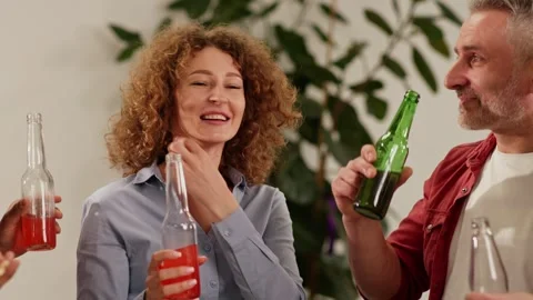 A group of diverse people communicate with each other and drink low-alcohol Stock Footage 243366889