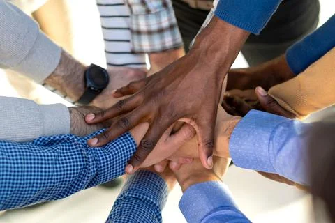 Group of diverse people stacking hands in the middle. Stock Photos
