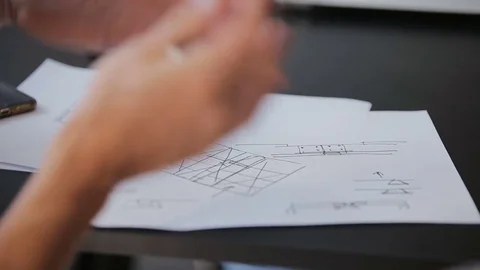 Group of diverse people teamwork business meeting planning architect drawings Stock Footage