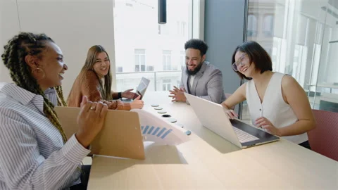 A Group of Diverse Professionals Engaging Effectively in a Modern Office Meeting Stock Footage 305493599