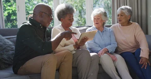 Group of diverse senior people using digital tablet together at home Stock Footage 162735007