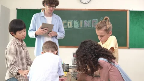 Group of diverse student working together while teacher hold tablet. Pedagogy. Stock Footage 274226826