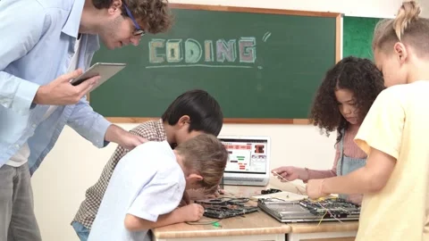 Group of diverse student working together while teacher hold tablet. Pedagogy. Stock Footage 274633213