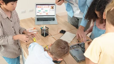 Group of diverse student working together while teacher hold tablet. Pedagogy. Stock Footage 283594531