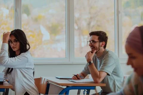 A group of diverse students engages in lively Stock Photos
