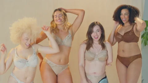 Diverse group of women in underwear, laughing together Stock Photo