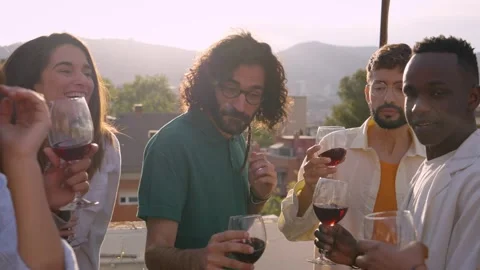 Group of diverse young friends dancing and drinking red wine celebrating Stock Footage 268024309