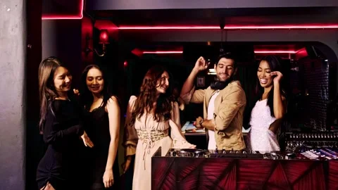 Group of diverse young people dancing and smiling with DJ at nightclub. Stock Footage 307916294