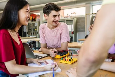Group of diverse young tech students learning together at technology class Stock Photos