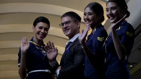 Group of diversity air hostess and steward waving hand to say goodbye to pass Stock Footage 147238420