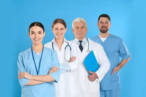 Group of doctors against blue background. Medical service Stock Photos