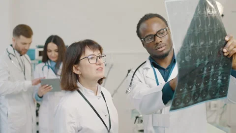 Group of doctors analyzing x-ray results Stock Footage 265260070