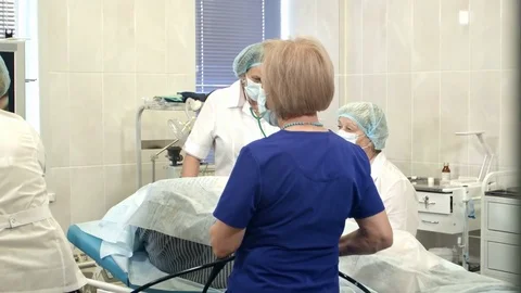 Group of doctors and nurses looking at the monitor during surgical operation Stock Footage 77365109