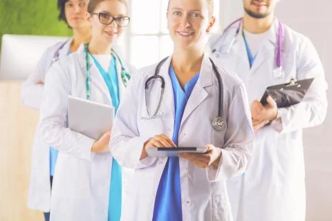 Group of doctors and nurses standing in the hospital room Stock Photos