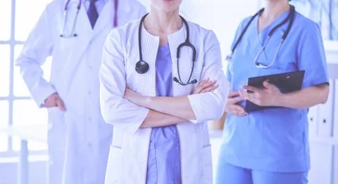 Group of doctors and nurses standing in the hospital room Stock Photos