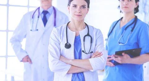 Group of doctors and nurses standing in the hospital room Stock Photos