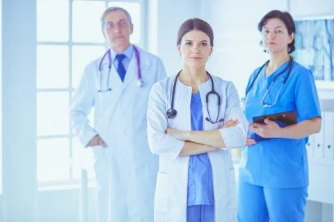 Group of doctors and nurses standing in the hospital room Stock Photos