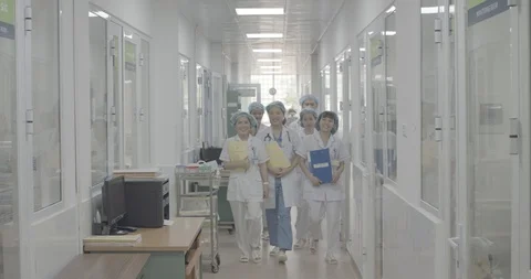 Group of doctors and nurses walking forward at the hospital corridor Stock Footage 127766187