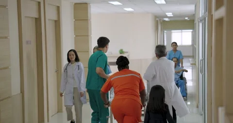 Group of doctors and nurses walking together through hospital corridor during Stock Footage 315549978
