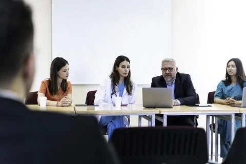 Group of doctors and nurses working together in a conference room at hospital Stock Photos