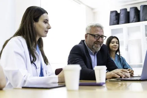Group of doctors and nurses working together in a conference room at hospital Foto stock