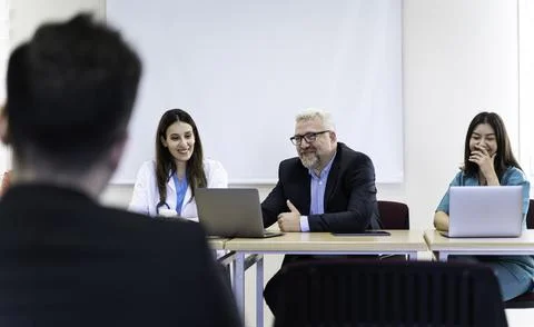 Group of doctors and nurses working together in a conference room at hospital Stock Photos