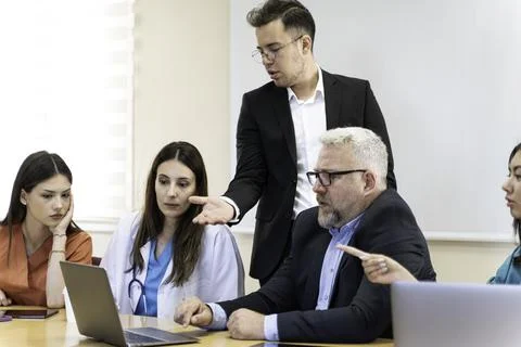 Group of doctors and nurses working together in a conference room at hospital Foto stock
