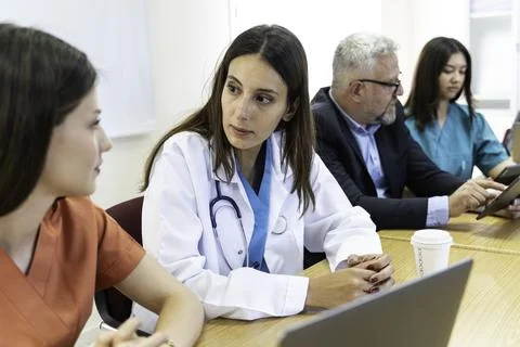 Group of doctors and nurses working together in a conference room at hospital Stock Photos