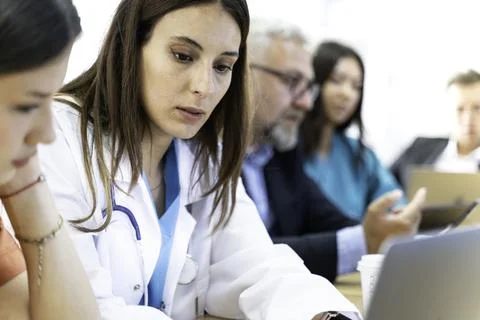 Group of doctors and nurses working together in a conference room at hospital Foto stock