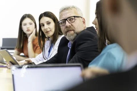 Group of doctors and nurses working together in a conference room at hospital Stock Photos