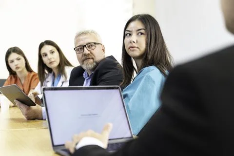 Group of doctors and nurses working together in a conference room at hospital Stock Photos