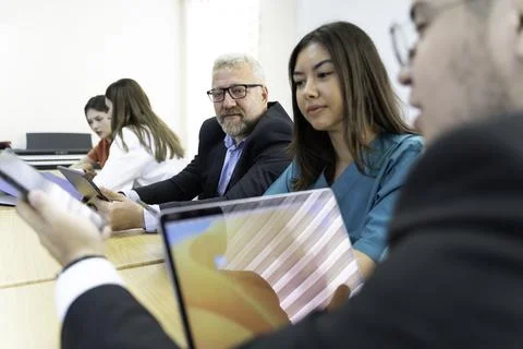 Group of doctors and nurses working together in a conference room at hospital Stock Photos