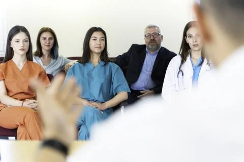 Group of doctors and nurses working together in a conference room at hospital Stock Photos