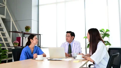 Group of doctors brainstorm meeting with computer laptop at the hospital. Stock-Footage 138070681