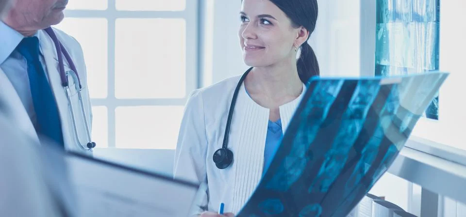 Group of doctors checking x-rays in a hospital Stock Photos