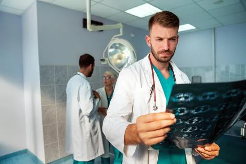 Group of doctors checking x-rays in a hospital. Stock Photos