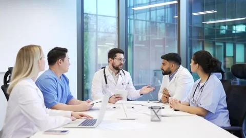 Group of doctors communicate at conference meeting in clinic office boardroom.  Stock Footage 319070341