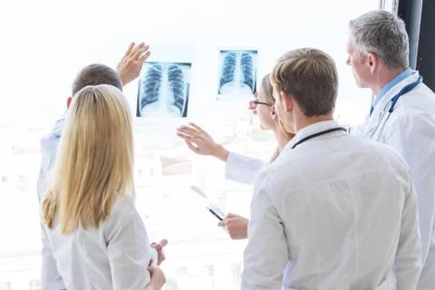 Group of doctors discuss x-ray Stock Photos