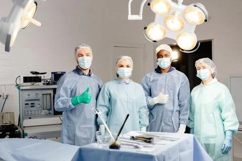 Group of doctors discussing patient cases around table Stock Photos