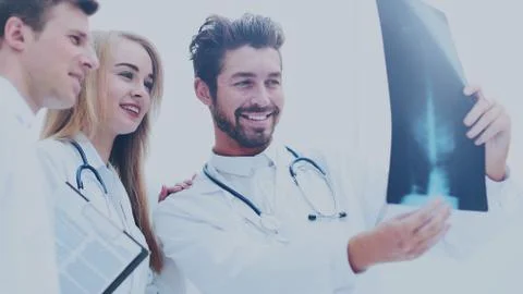 A group of doctors examining an x-ray in the hospital Stock Photos