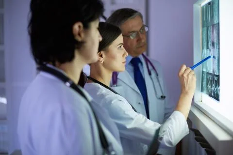 Group of doctors examining x-rays in a hospital Stock Photos
