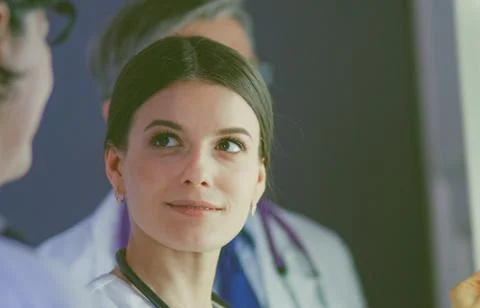 Group of doctors examining x-rays in a clinic, thinking of a diagnosis Stock Photos
