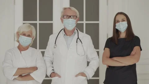 Group of doctors with face masks looking at camera Video stock 141224369