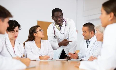 Group of doctors having discussion in classroom of medical university Stock Photos