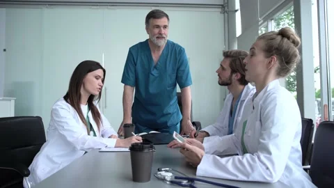 Group of doctors looking at X-ray on medical conference Stock Footage 135186045