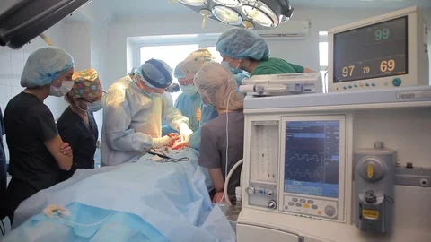 Group of doctors in the middle of the surgery. Surgeons operate patient. Stock Footage 99198592