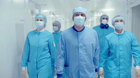 Group of doctors in protective masks and medical uniform walking down Stock Footage 200855952