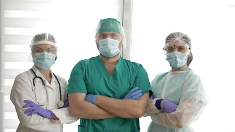 Group of doctors in protective suits is ready to go. Covid-19. Stock Footage 129429349